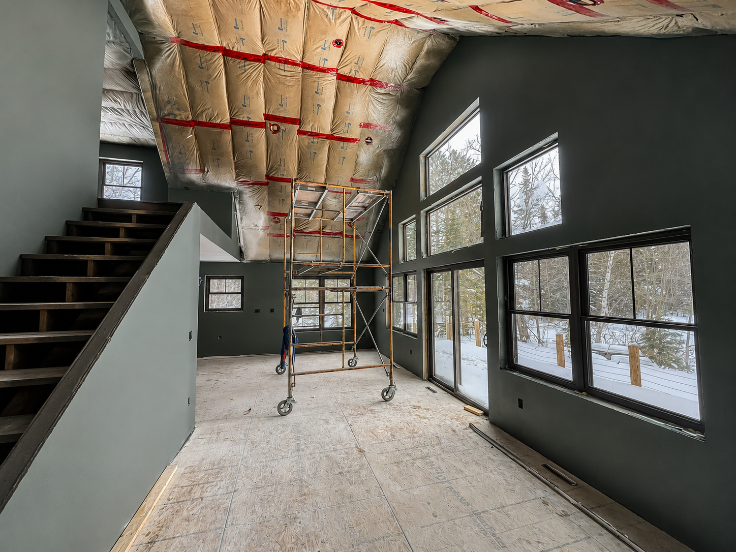 Finished drywall detail — painted walls, crisp corners and tall window openings